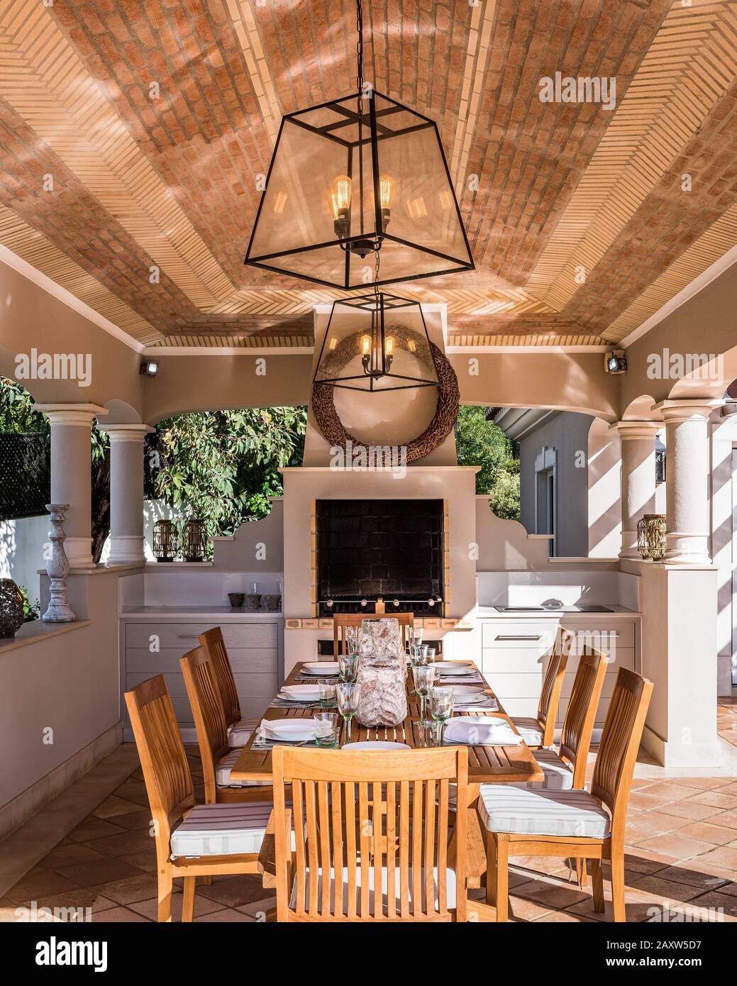 Set table by fireplace on patio Stock Photo Alamy