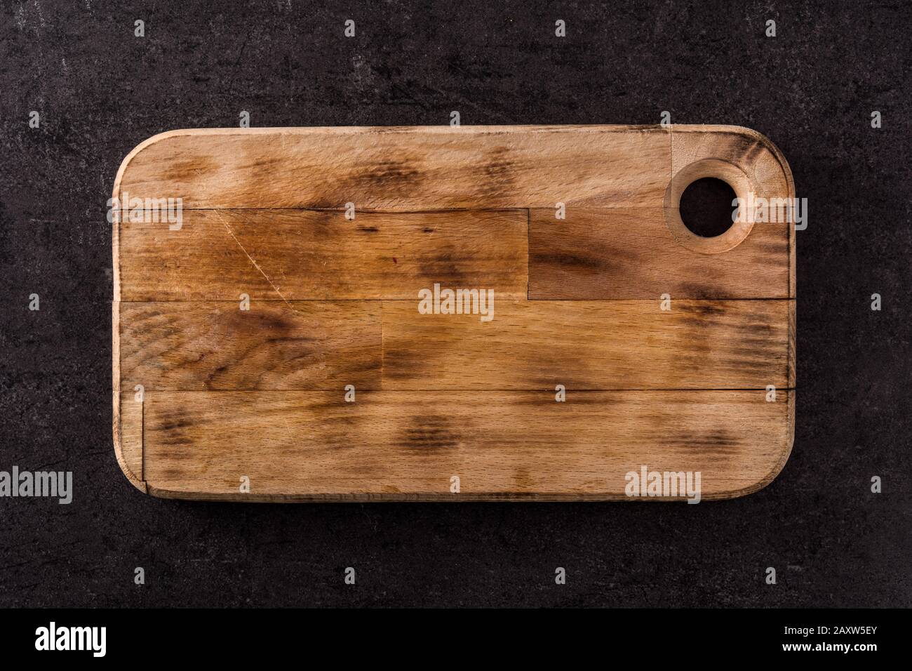 Cutting board on black slate background. Mockup Stock Photo