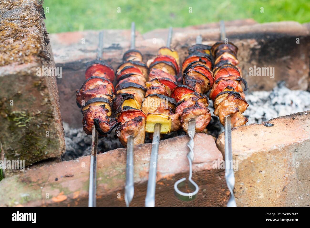 Pork skewers with onions. In a homemade grill Stock Photo Alamy