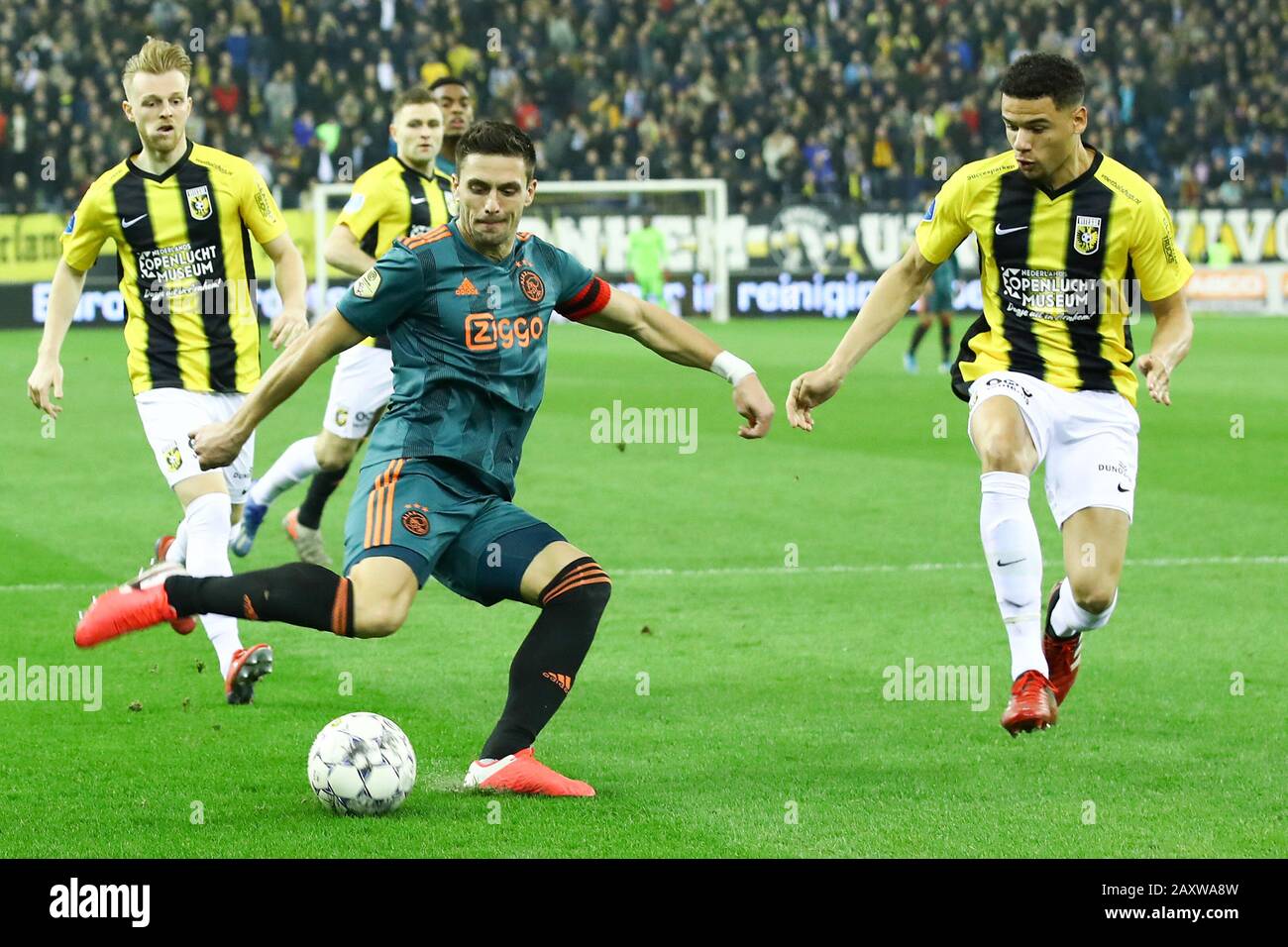 12 february 2020 Arnhem, The Netherlands Soccer Vitesse v Ajax Amsterdam  L-r: Max Clark of Vitesse, Dusan Tadic (captain) of Ajax , Armando Obispo of Vitesse Stock Photo