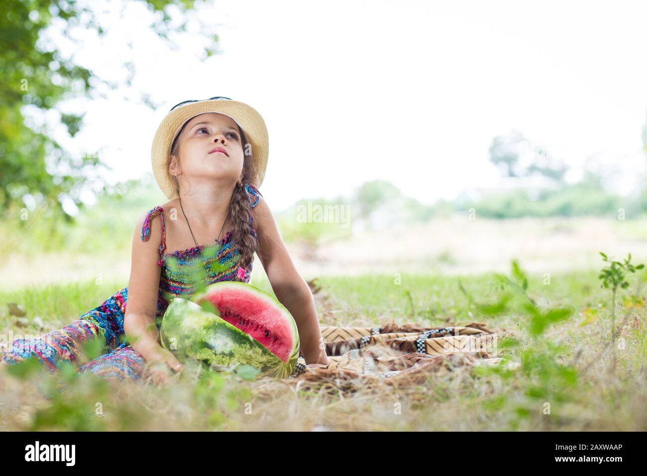 Cute little girl at summer picnic. Girl on sraw hat and sunglesses with