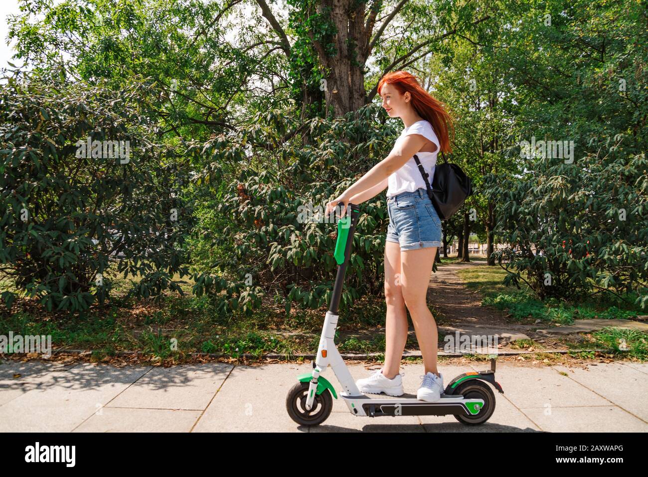 Female rides electric scooter hi-res stock photography and images - Alamy