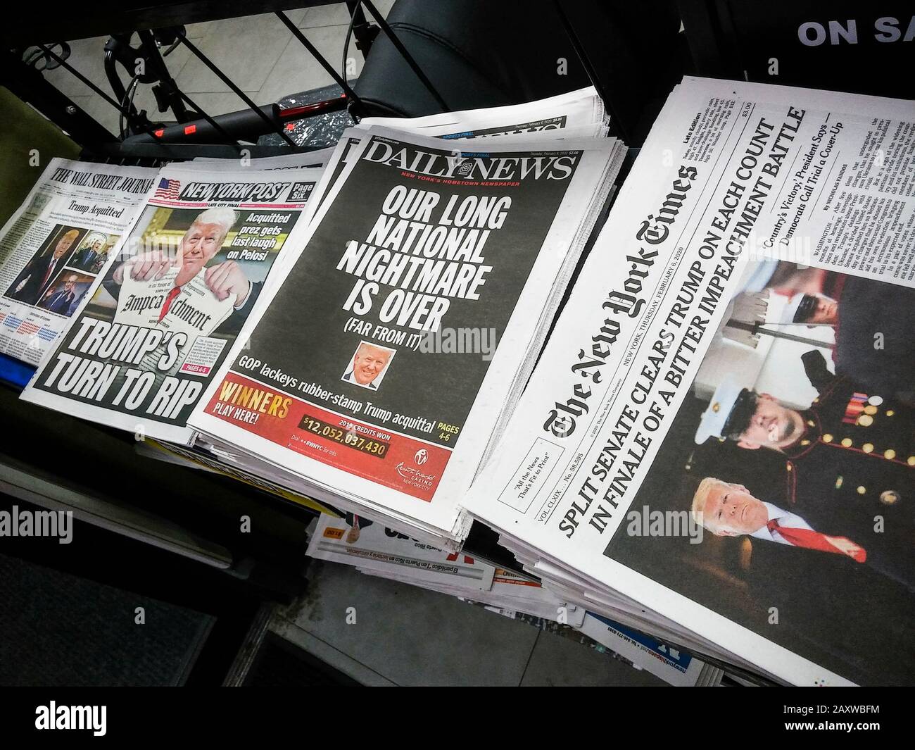 Headlines of newspapers in New York on  a newsstand on Thursday, February 6, 2020 report on the previous day’s acquittal of  impeachment of President Donald Trump. (© Richard B. Levine) Stock Photo