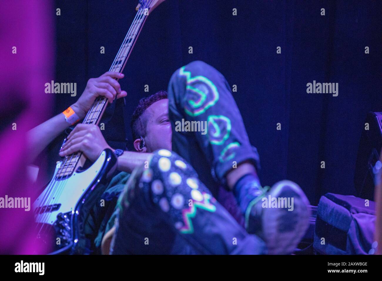 Still Woozy live concert at SLO , California. Yonatan Tietz and Peter Johnston Drums are lying on the floor, goofing off. Skinny Pete at stage show. Stock Photo