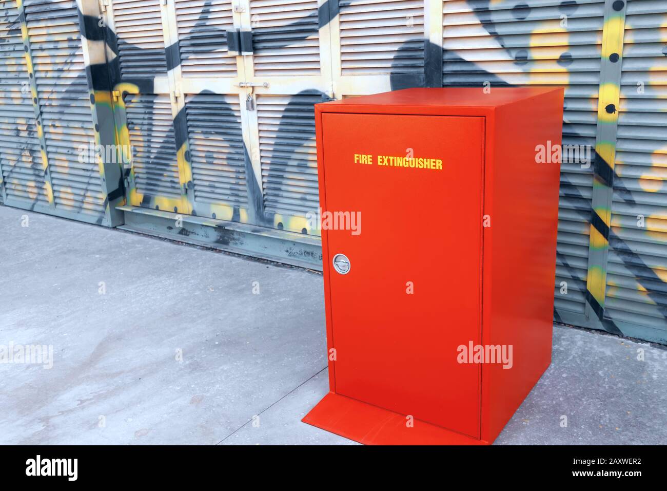 Fire Extinguisher red closet standing near building Stock Photo