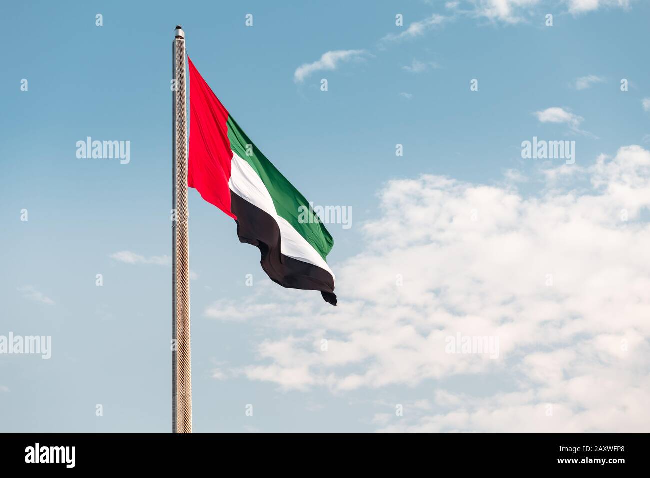 United Arab Emirates flag at blue sky background Stock Photo
