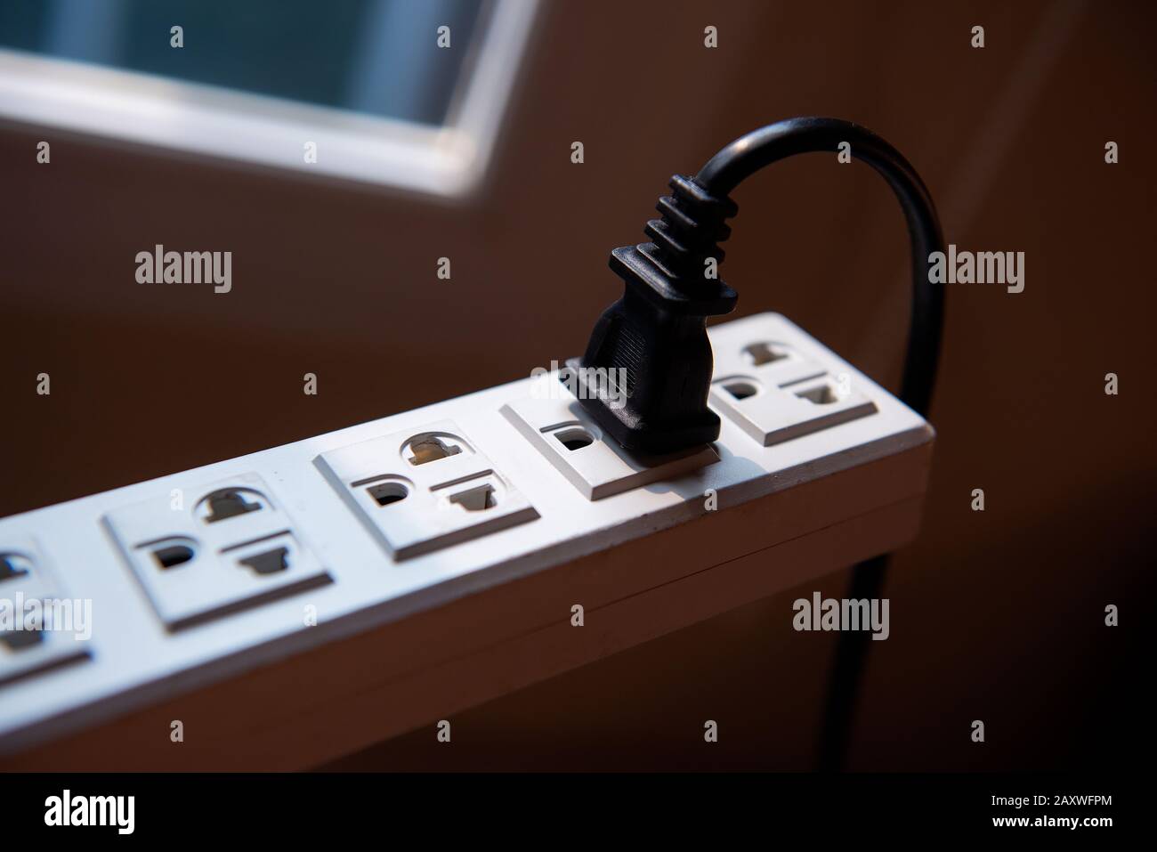Close up plugging into electrical outlet Stock Photo Alamy