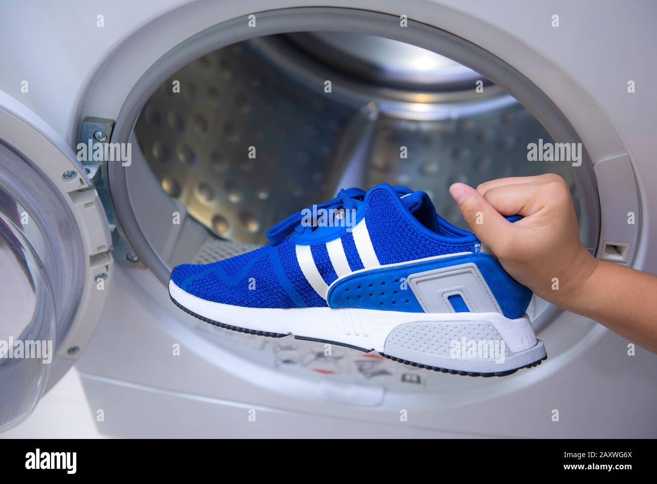 cleaning dirty footwear in a washing machine at home. Shoes care Stock  Photo - Alamy