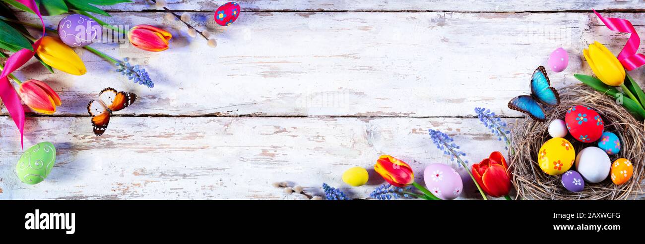 Easter Painted Eggs And Tulips On White Plank Stock Photo