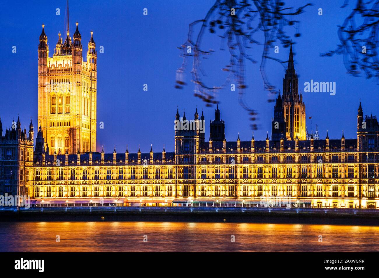 The Houses of Parliament along the river Thames in London at night. Stock Photo
