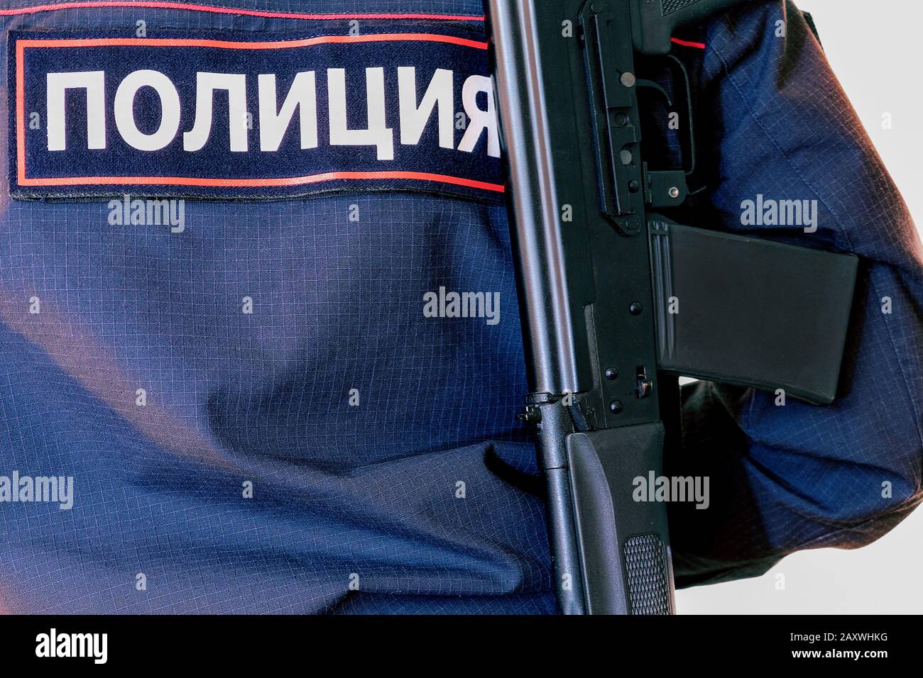 Police officer. With weapons in service. Performs official duties. The inscription in Russian police Stock Photo