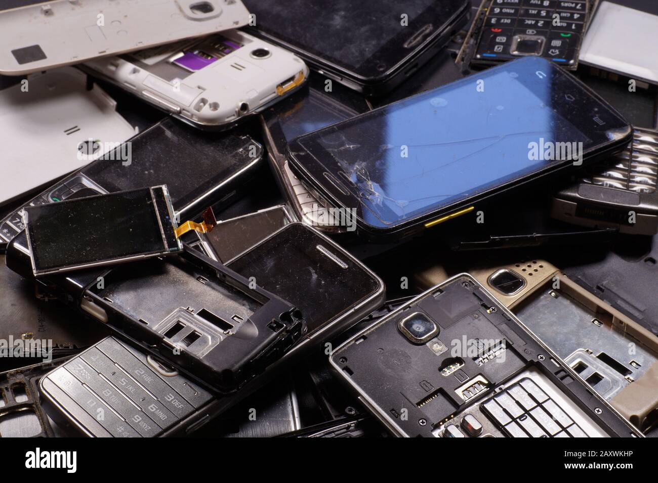 Electronic scrap. Different phones and smartphones not suitable for repair. Stock Photo