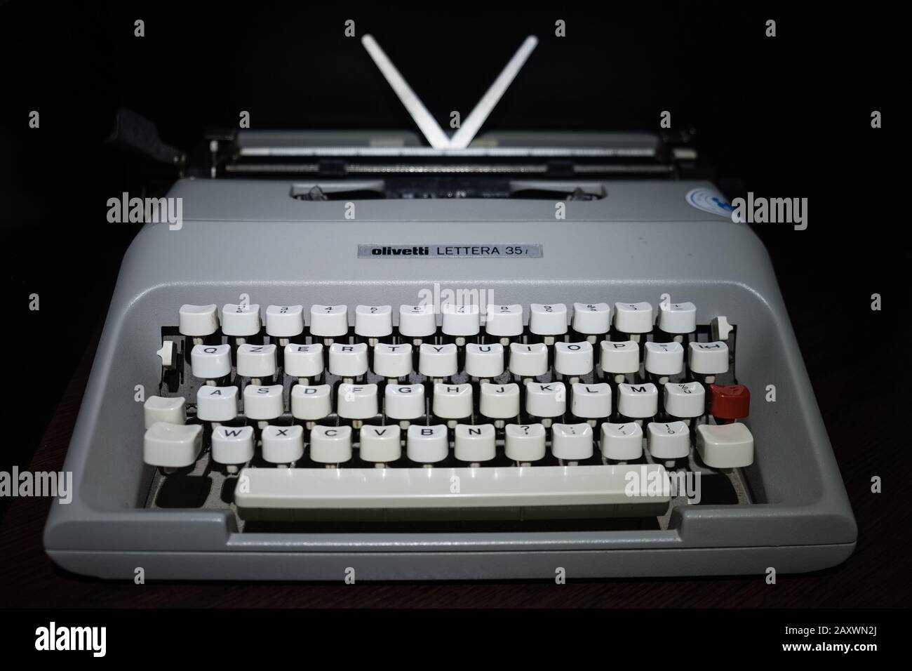 Typewriter 'Olivetti' model 'Letter 35' photographed frontally on a dark background. Stock Photo