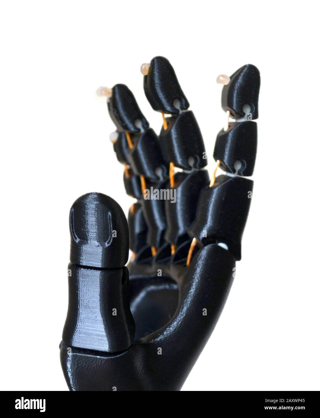 Robot hand fingers from plastic. Isolated on white background. Automatic three dimensional performs plastic modeling. Modern 3D printing technology. Stock Photo