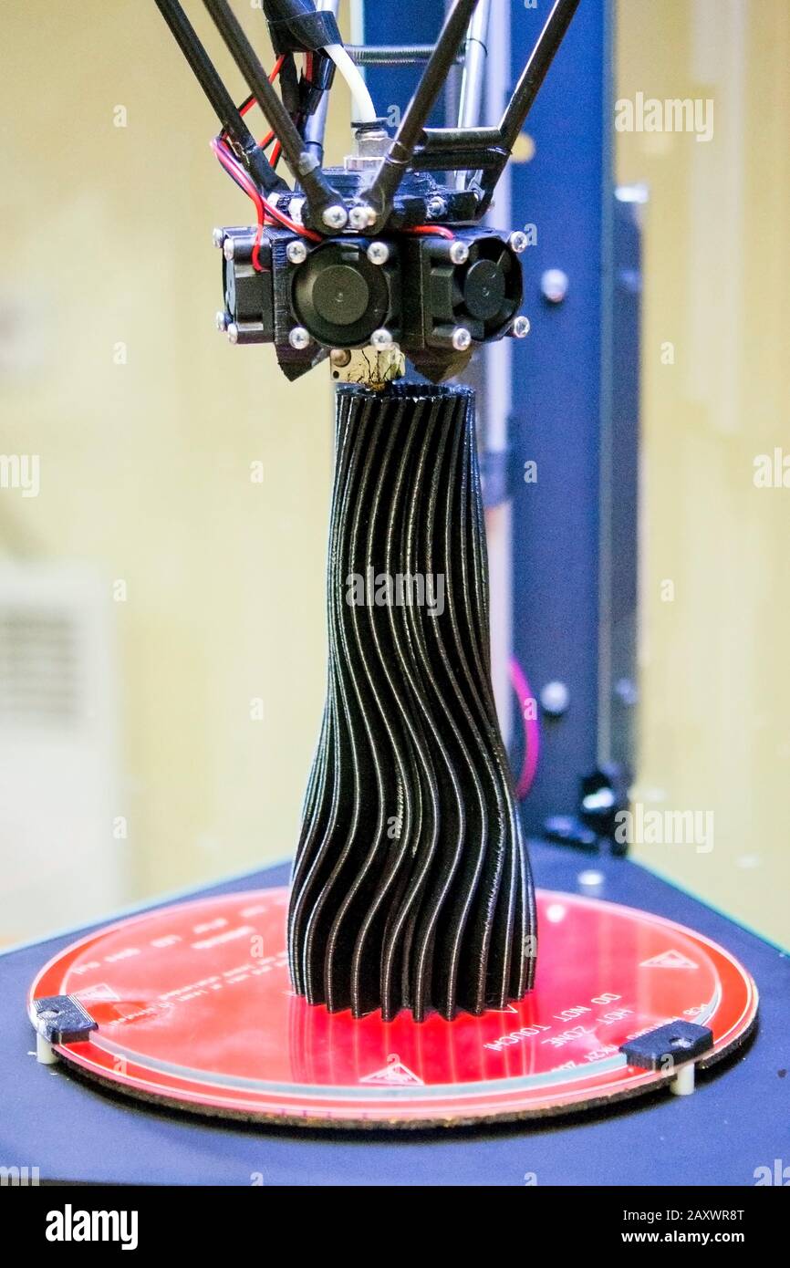 Printing a black object in the form of a vase 3d with a printer close ...