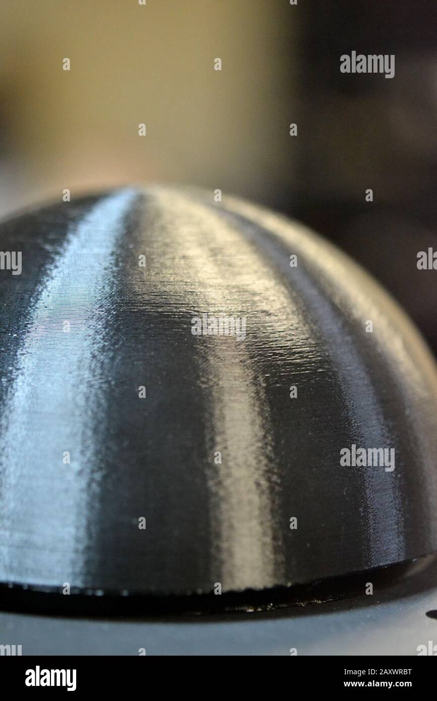 black object printed 3d by the printer macro close-up. Progressive ...