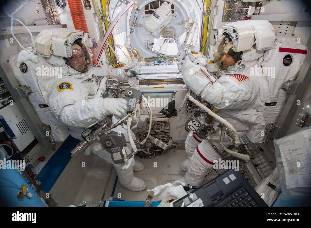 ISS - 6 Oct 2019 - NASA astronauts Andrew Morgan (left) and Christina Koch (right) are suited up in US spacesuits inside the Quest airlock before begi Stock Photo