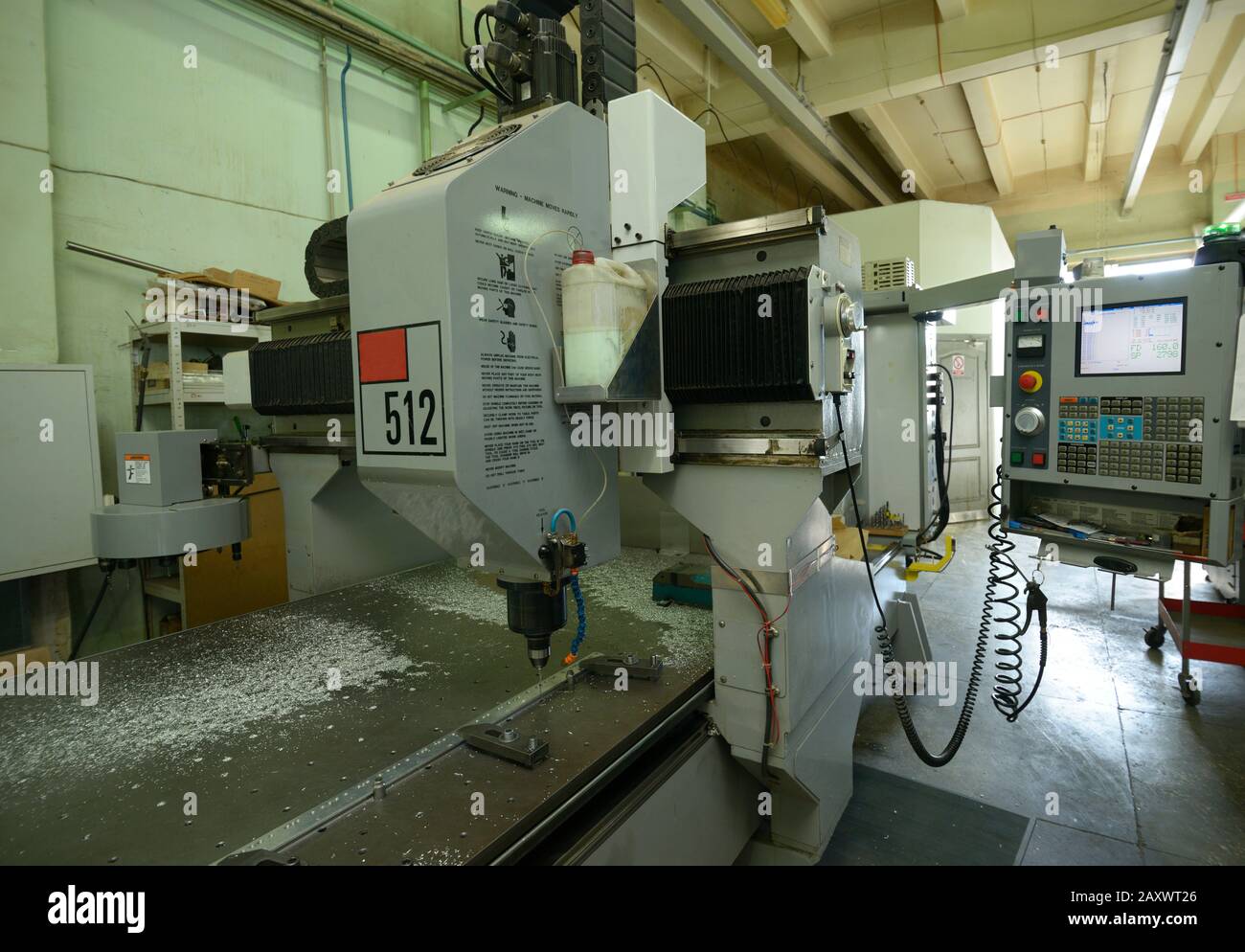 Computer numerical control milling machine set for work, drill boring hole in a metal piece