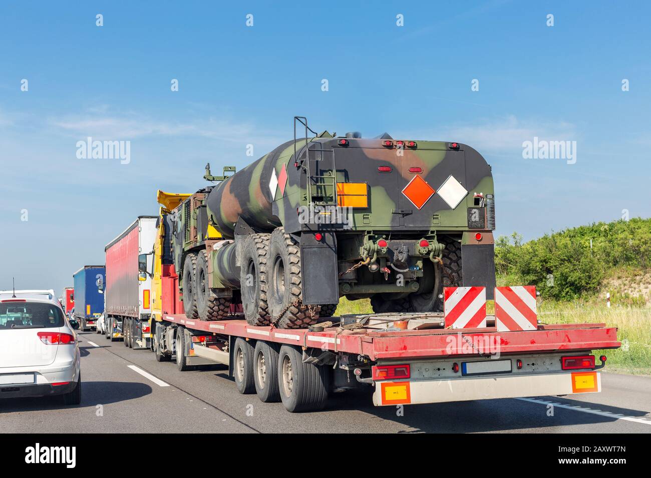 Car towing truck with heavy duty military army fuel tanker Stock Photo