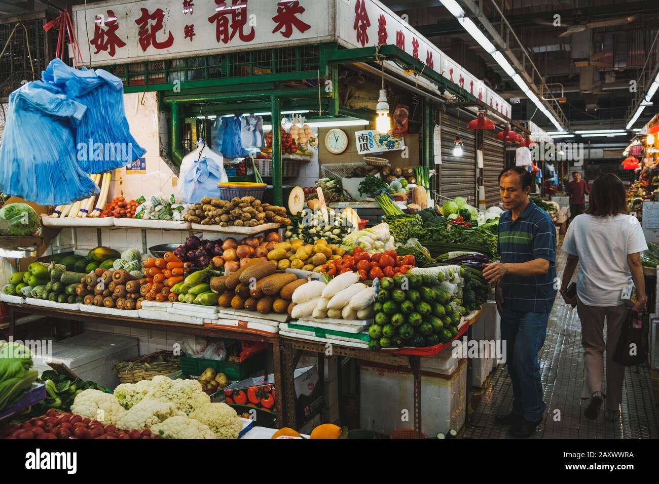 Hong Kong - November, 2019: Market stand selling vegetables  inside street food market centre in Hong Kong Stock Photo