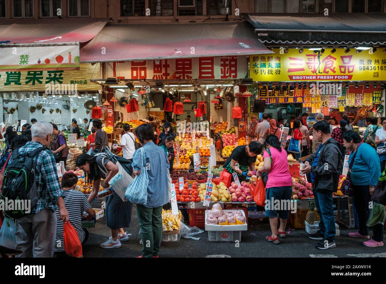 Hong Kong - November, 2019: People buying groceries on crowded street food market in Hong kong Stock Photo