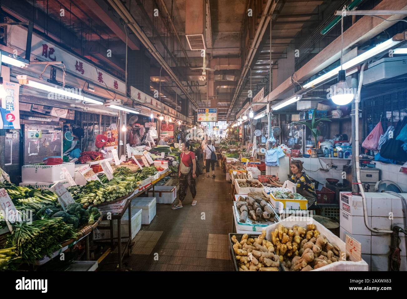 Hong Kong - November, 2019: People buying and selling groceries at shop inside street food market centre in Hong Kong Stock Photo