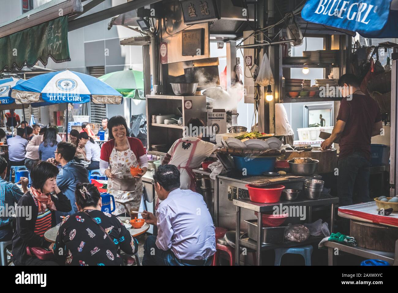 Hong Kong - November, 2019: People sitting in crowded street food restaurant eating lunch  in Soho, Hong Kong Stock Photo