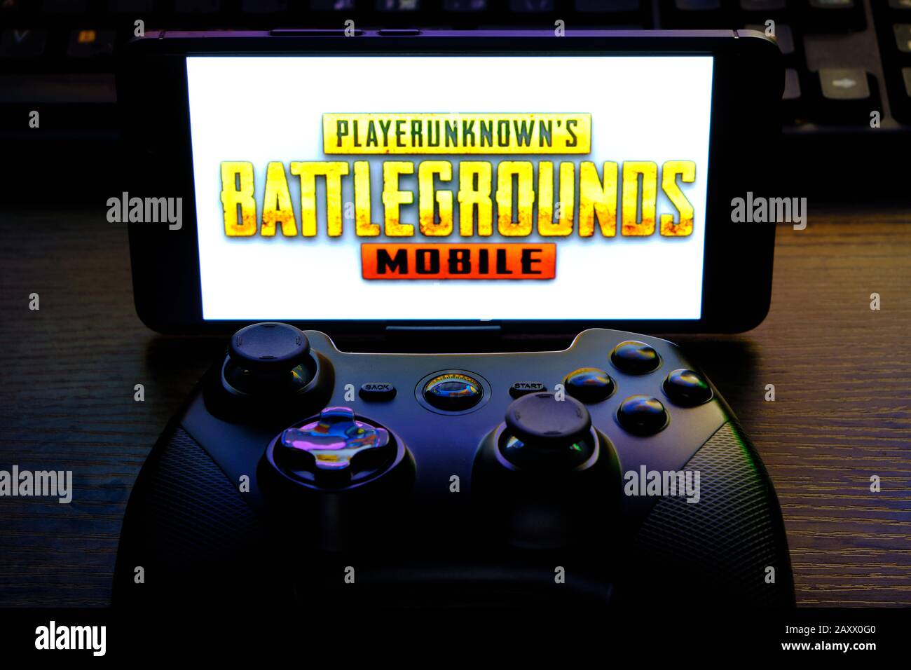 Kostanay, Kazakhstan, February 12, 2020.Joystick and mobile phone with the logo of the popular game Playerunknown's Battlegrounds abbreviated PUBG. Stock Photo