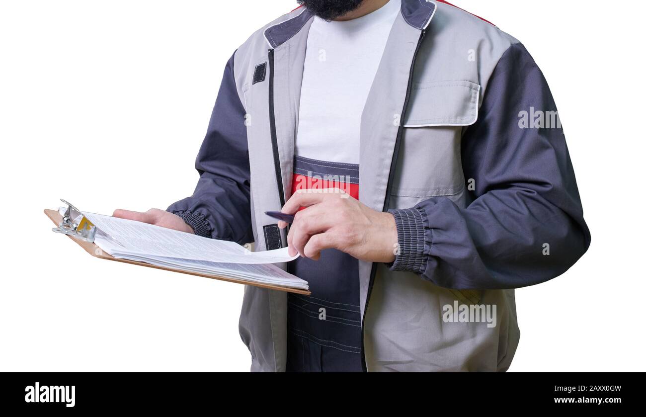 Concentrated young technician wearing overall standing and taking some notes Stock Photo
