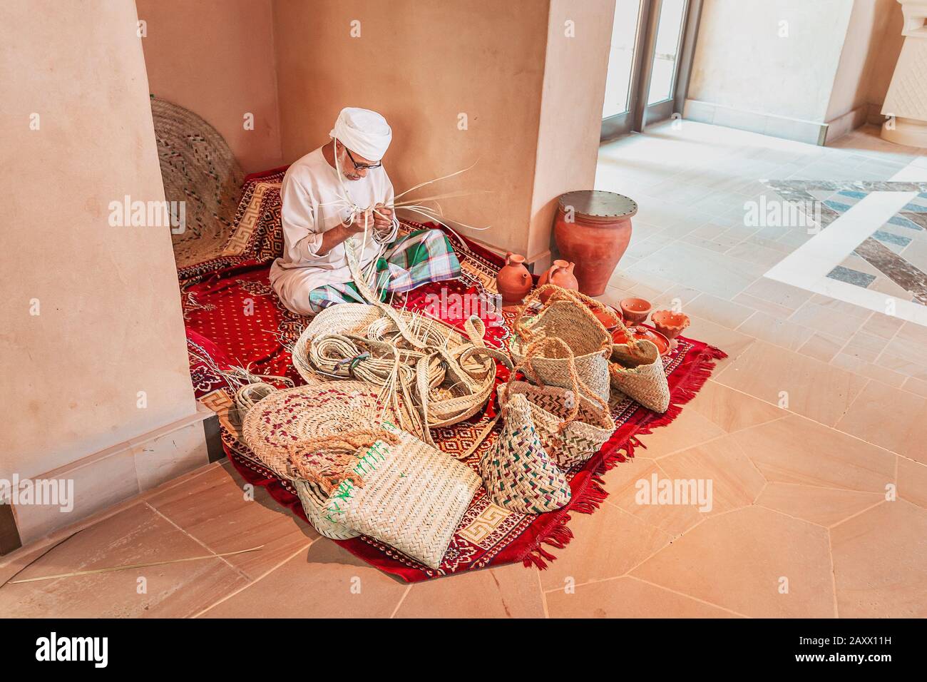 27 November 2019, Dubai, United Arab Emirates An old artisan weaves