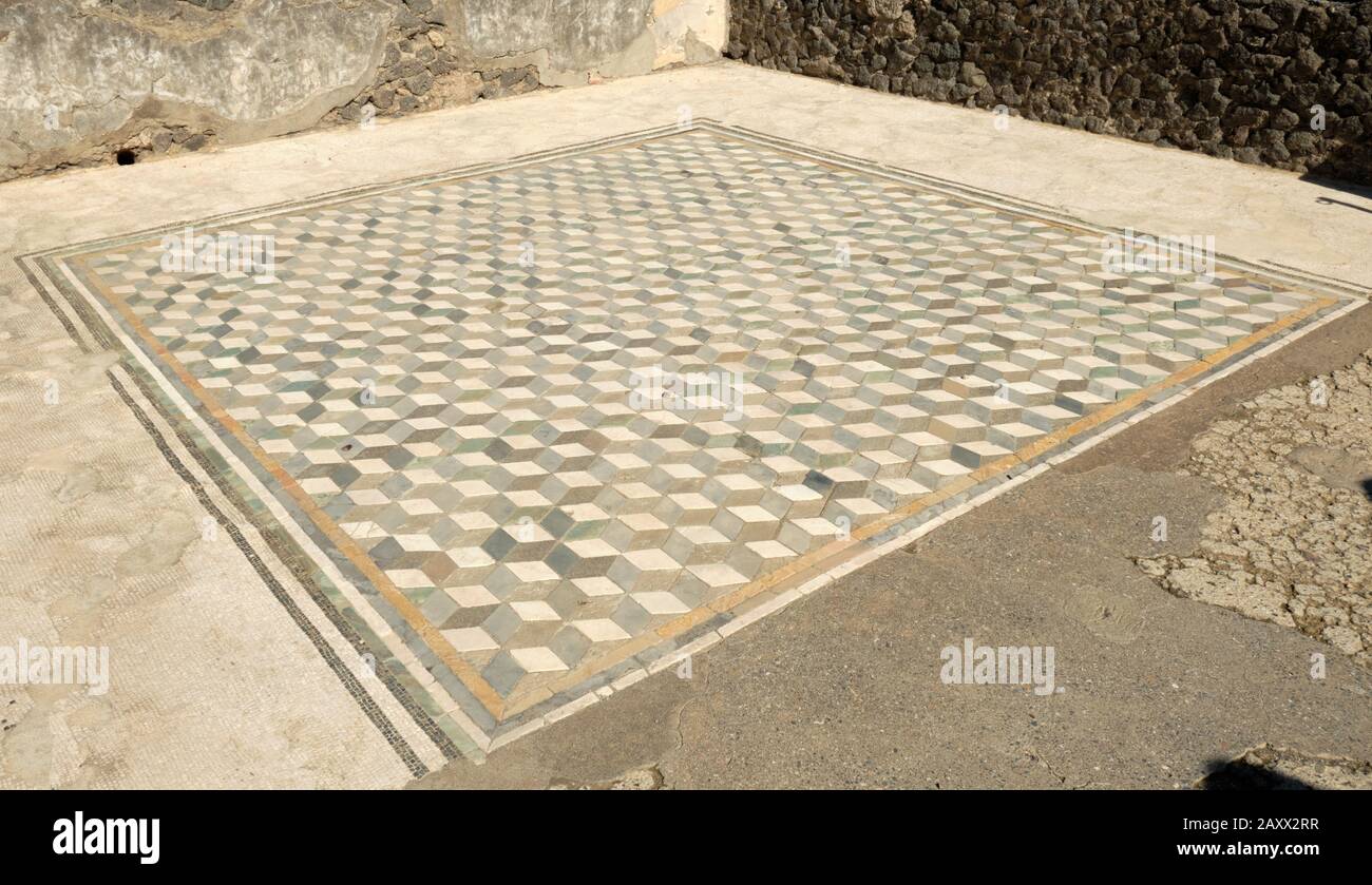 A Roman mosaic floor depicts an optical illusion at the House of the Faun in Pompeii, Italy Stock Photo