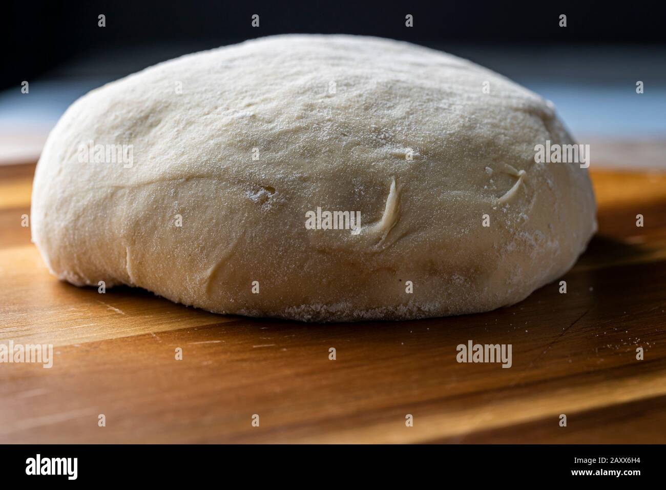 Pizza dough resting on wooden peel. Stock Photo
