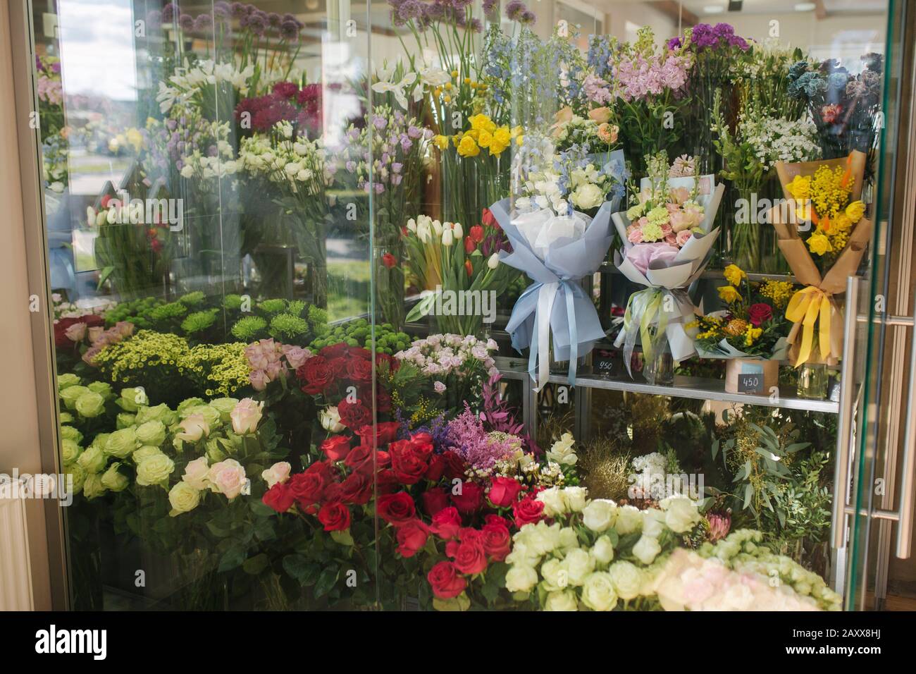 Different varieties fresh spring flowers in refrigerator room for
