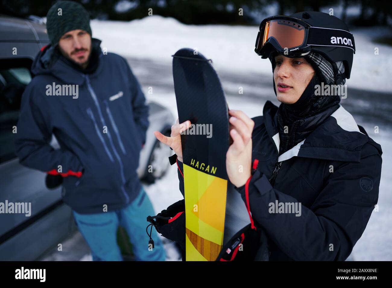 Female tour skier putting skins on her skis. Stock Photo