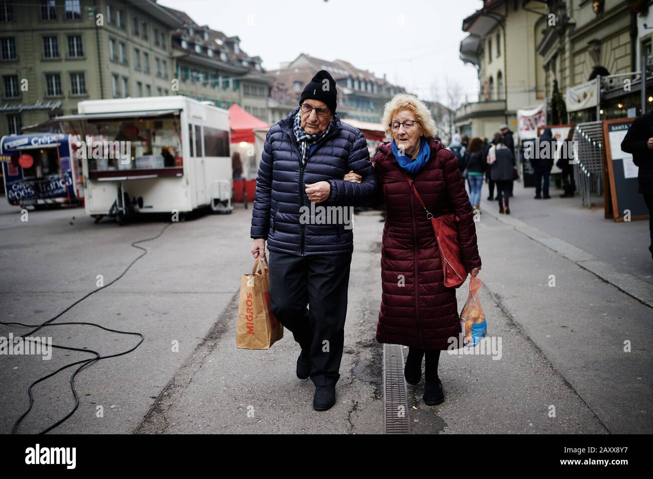 Alderley retired couple walking down a street in Bern, Switzerland Stock Photo