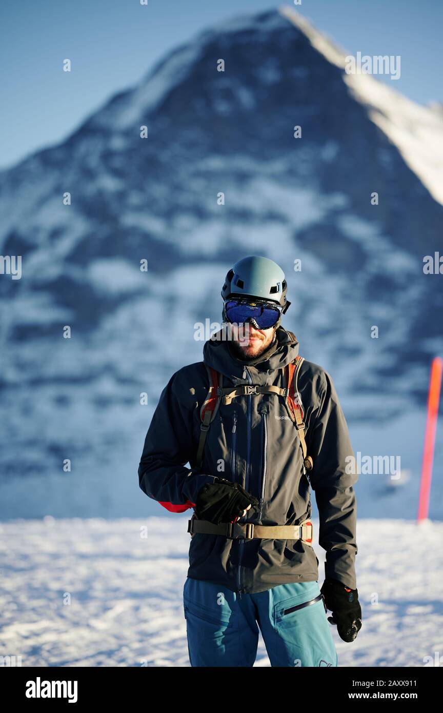 A skier posing in front of the Eiger north face in Switzerland Stock Photo