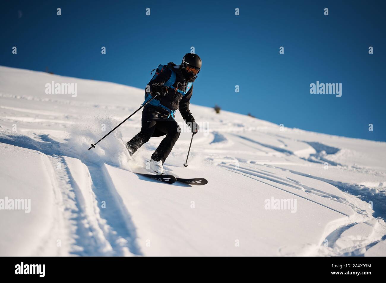 Tour skier enjoying powder conditions in Switzelrand. Stock Photo