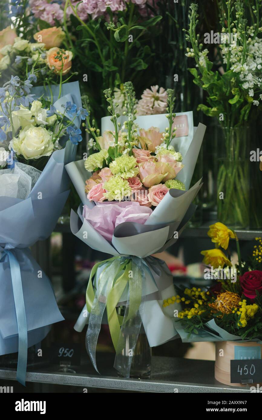 Different varieties fresh spring flowers in refrigerator room for