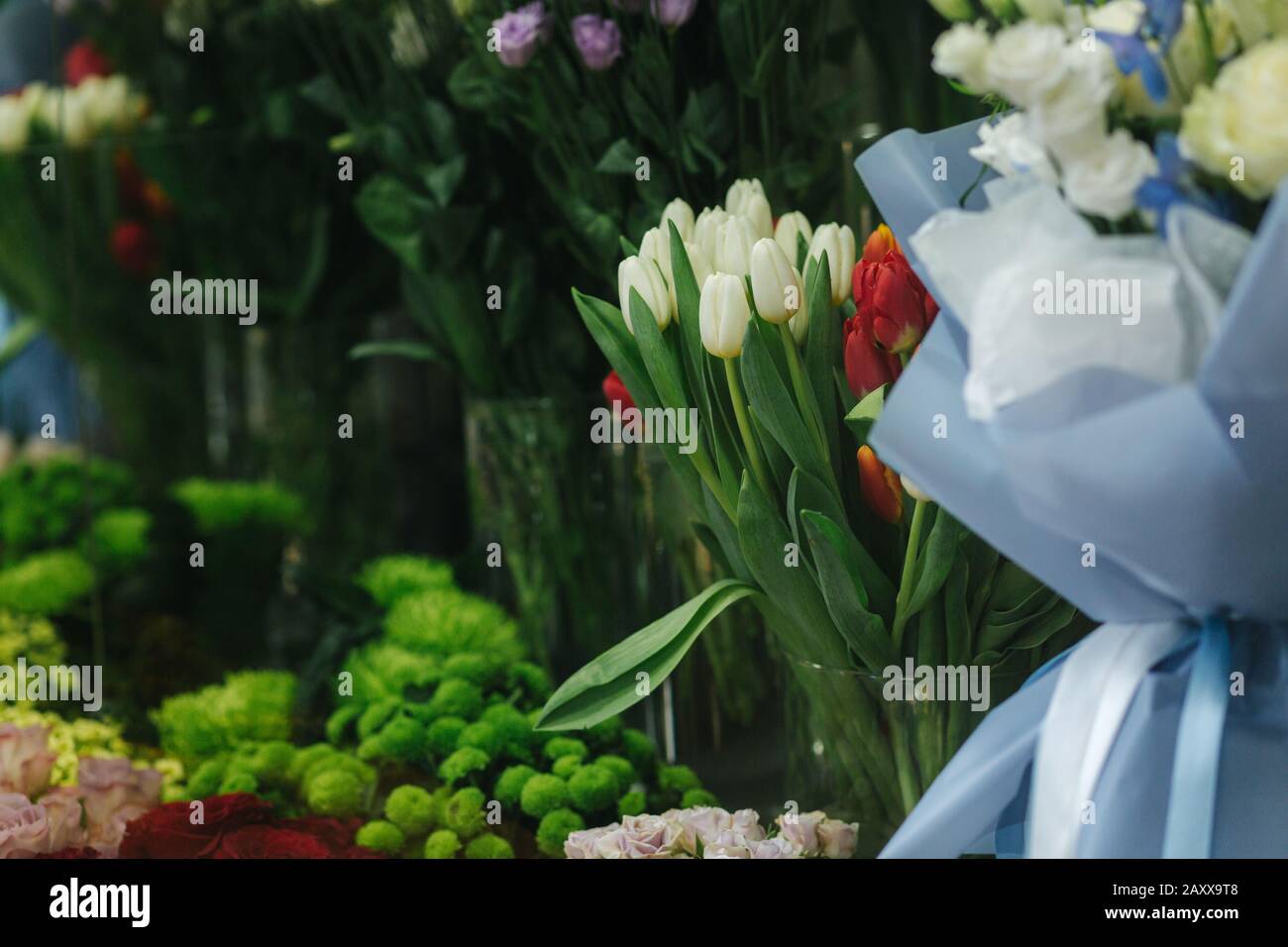 Different varieties fresh spring flowers in refrigerator room for