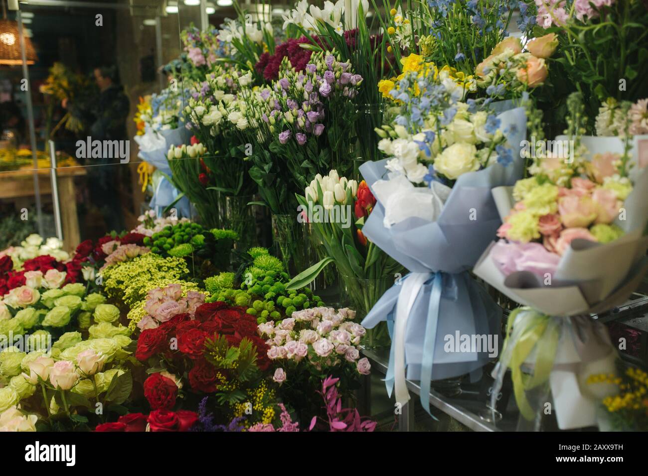Different varieties fresh spring flowers in refrigerator room for
