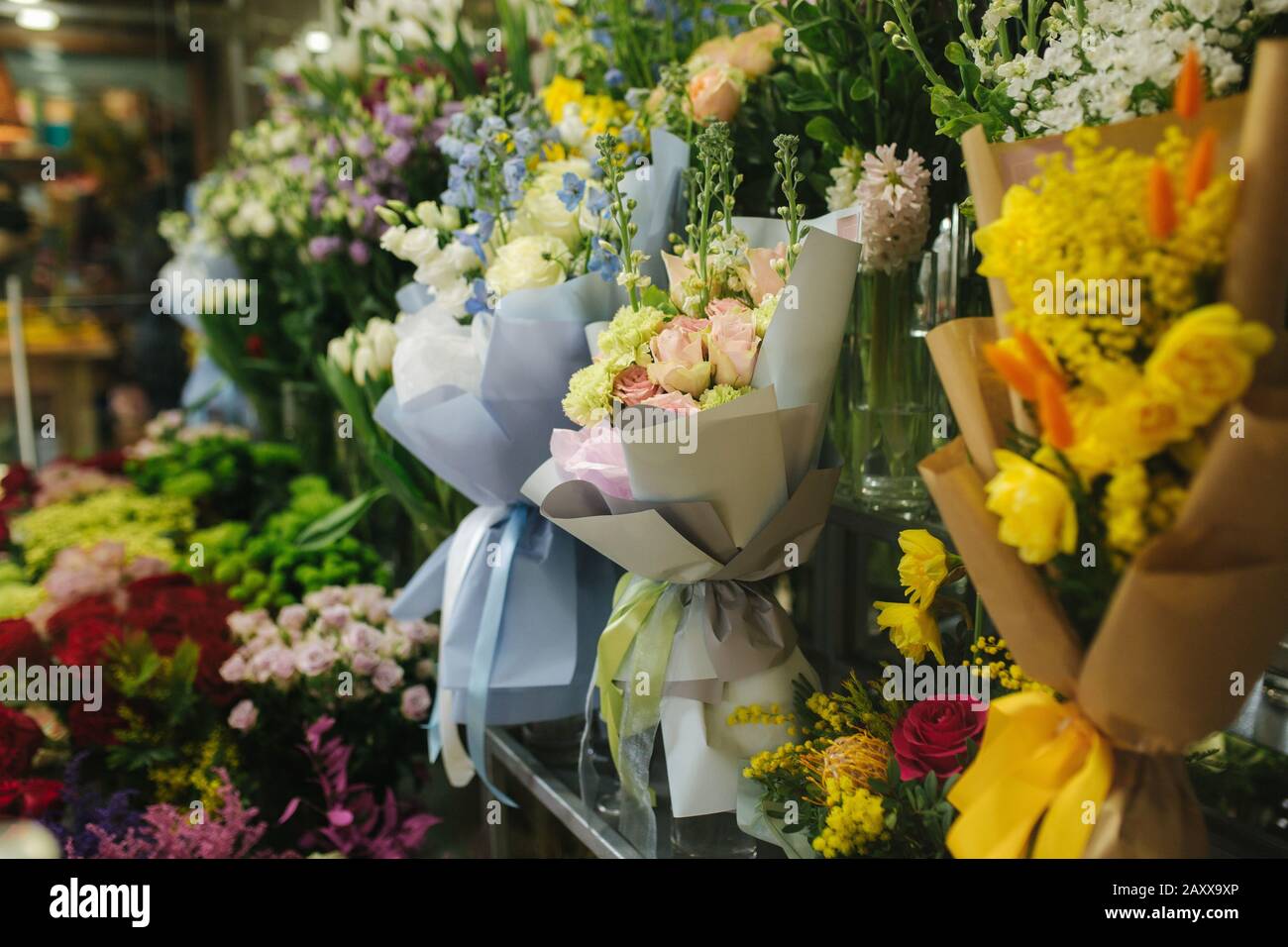 Different varieties fresh spring flowers in refrigerator room for