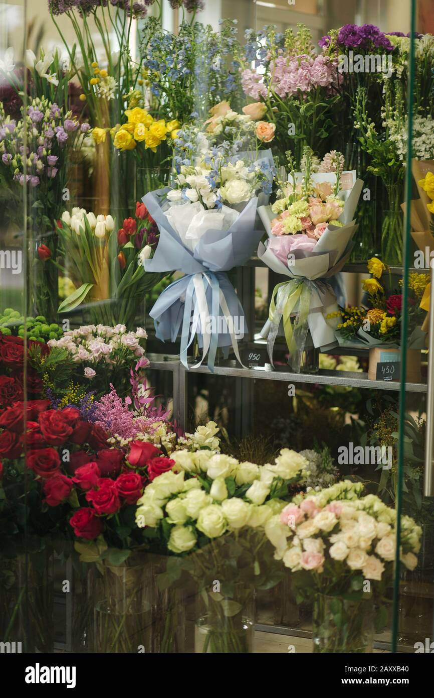 Different varieties fresh spring flowers in refrigerator room for
