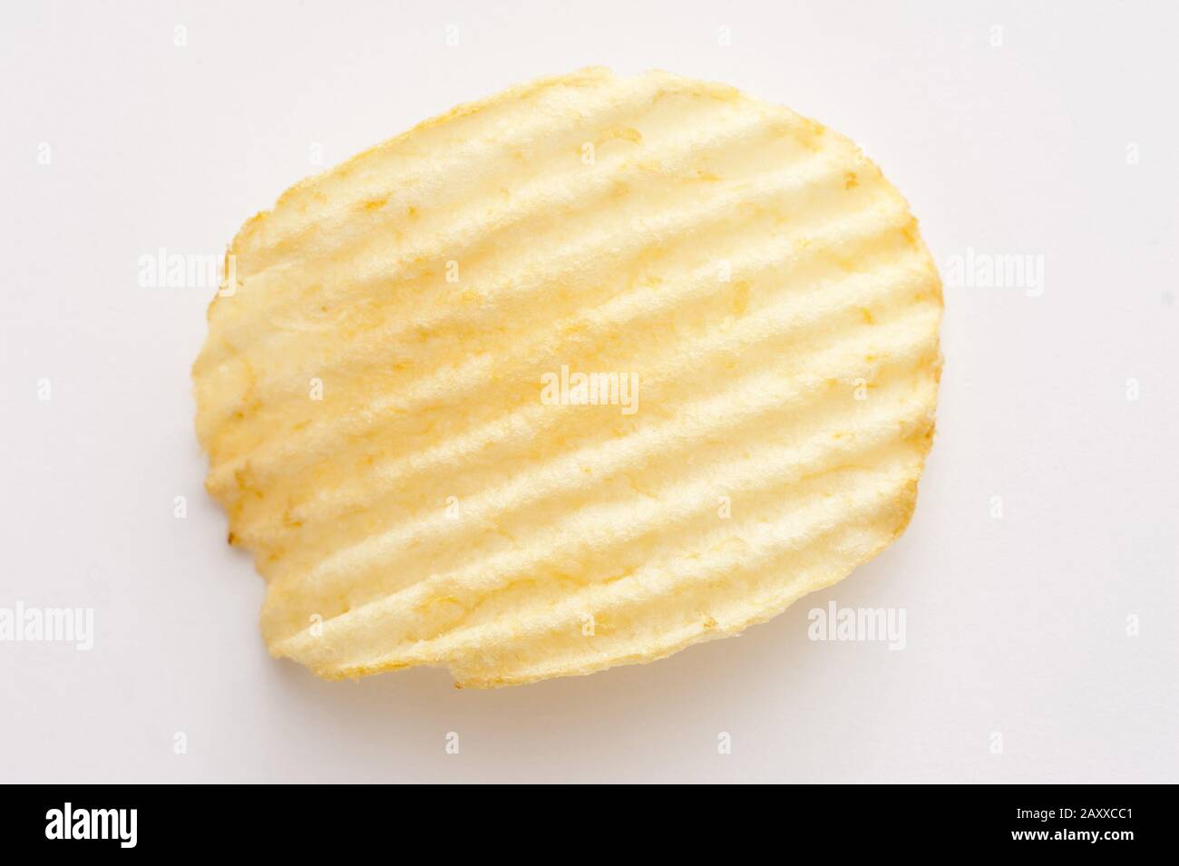 Single crinkle cut potato crisp or chip on a white background viewed