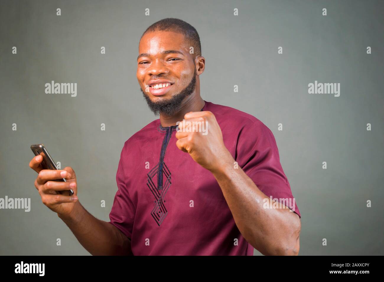 young handsome african boy feels overwhelm bout what he saw on his mobile  phone Stock Photo - Alamy