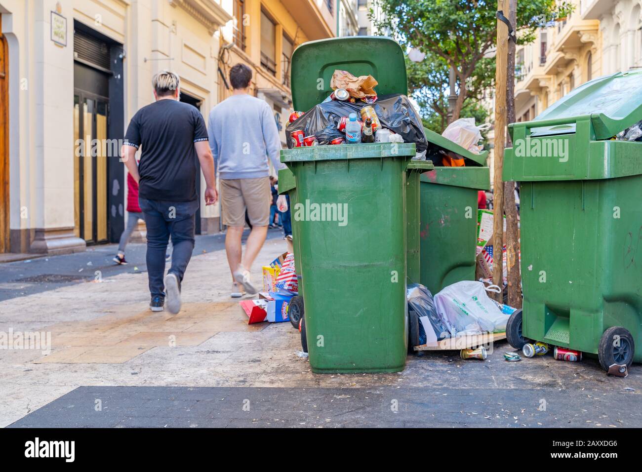 Valencia,Spain - March 16, 2019:  Garbage at the street and full bins. Extreme contamination during celebration of Fallas in Valencia city. Empty bear Stock Photo