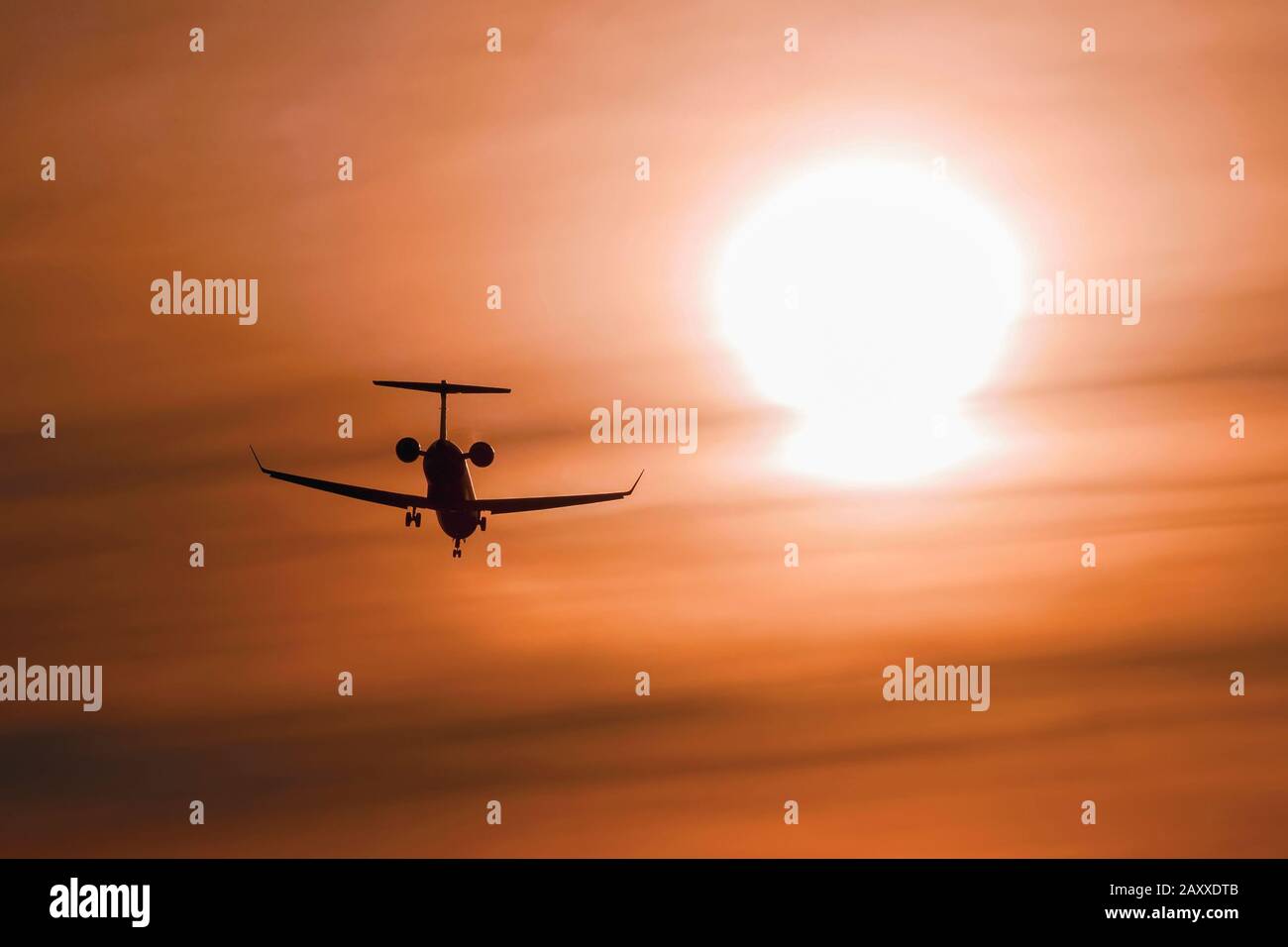 Silhouette of a jet airplane landing at sunset. Phoenix Int. Airport. Phoenix, Arizona Stock Photo
