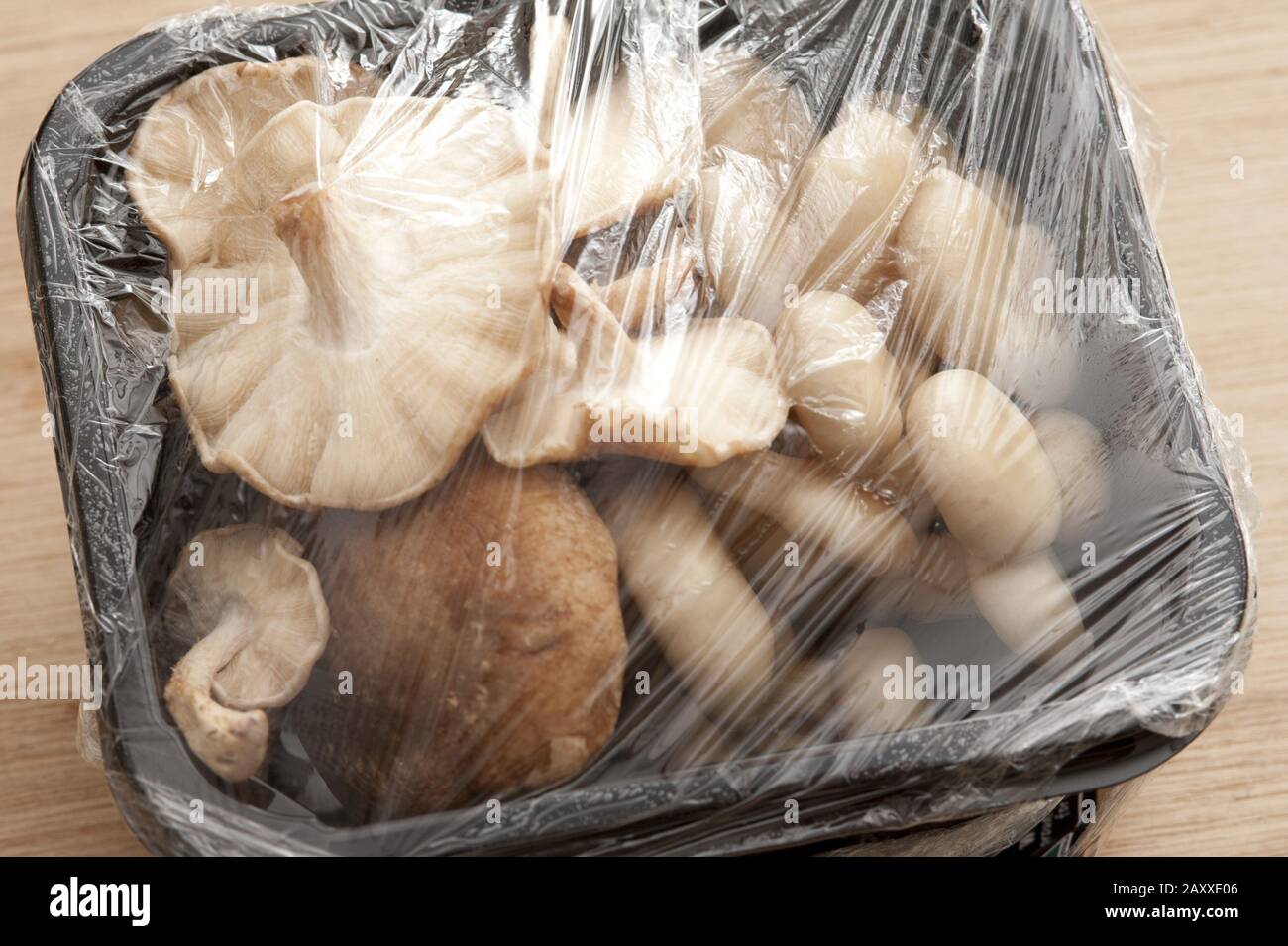 Prepacked mushrooms in a punnet covered with clear plastic