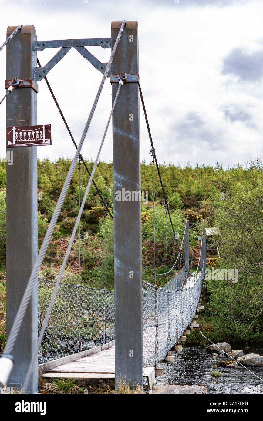 Gruids suspension bridge leading to Lairg Train station Stock Photo
