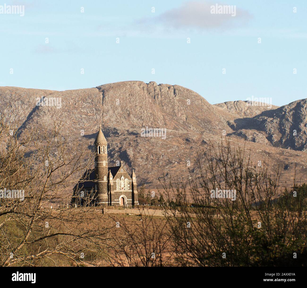 Roman Catholic Church of The Sacred Heart, Dunlewey, Co. Donegal, Ireland under a blue sky with with mountain in background Stock Photo