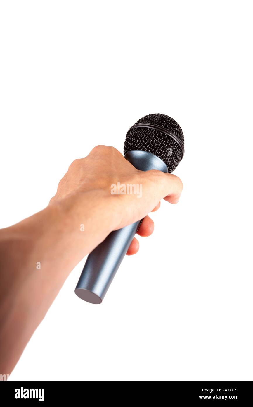 A hand holding out a simple wireless microphone away from the viewer isolated on white Giving voice to someone, speaking up, public speech Stock Photo